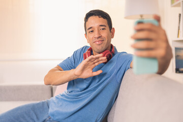 Man waving during a video call with a mobile phone