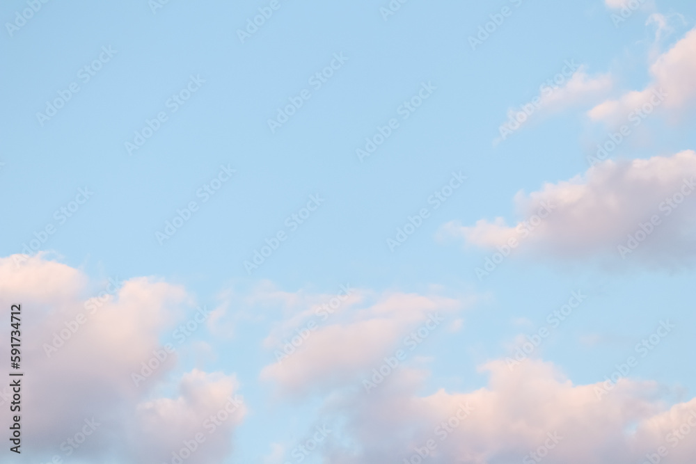 Wall mural blue sky background with pale pink clouds at sunset