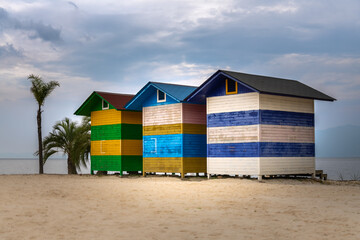 Fuxian Lake Gushan Scenic Area with wooden houses, cloudy dramatic sky, copy space for text
