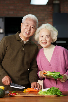 Elderly couple in the kitchen cooking