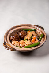 braised assorted dried seafood sea cucumber mushroom bean curd skin and broccoli mixed vegetables in sauce casserole on wood table asian chinese halal food banquet menu for restaurant