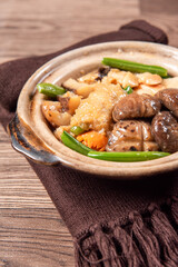 braised assorted dried seafood sea cucumber mushroom bean curd skin and broccoli mixed vegetables in sauce casserole on wood table asian chinese halal food banquet menu for restaurant