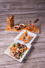 stir fried white shimeji mushroom with scallop black fungus cashew nut deep fried yam bean curd and mixed colourful vegetables on wood table asian Chinese vegan halal food banquet menu for restaurant