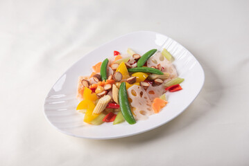 stir fried white shimeji mushroom with scallop black fungus cashew nut deep fried yam bean curd and mixed colourful vegetables on wood table asian Chinese vegan halal food banquet menu for restaurant
