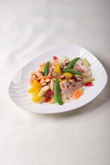 stir fried white shimeji mushroom with scallop black fungus cashew nut deep fried yam bean curd and mixed colourful vegetables on wood table asian Chinese vegan halal food banquet menu for restaurant