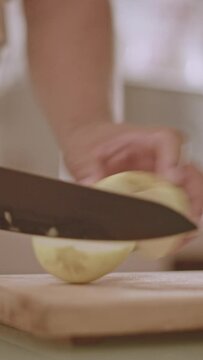 slicing an apple on a chopping board