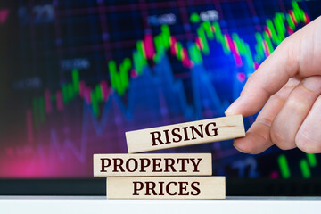Wooden blocks with words 'Rising property prices'. Business concept