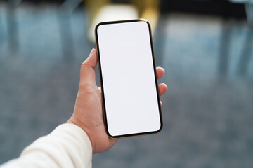 Women's hands holding cell telephone blank copy space screen. smartphone with blank white screen isolated. smart phone with technology concept