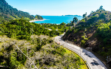 Fototapeta na wymiar Aerial shot of coastal landscape with sea, road and hills