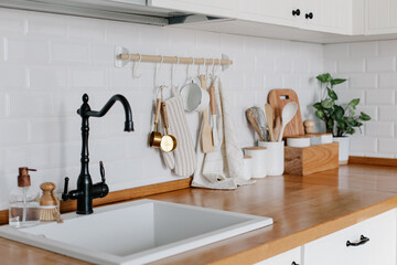 View of white modern country style kitchen interior with hanging storage, eco friendly food storage.