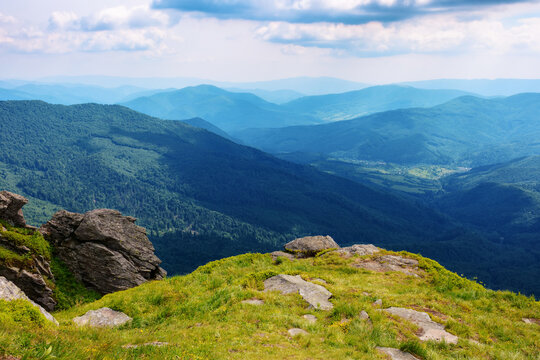 carpathian watershed ridge. stones and boulders on the green grassy hills. hot summer day