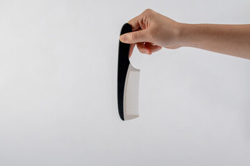 Hand and hair comb isolated on white background