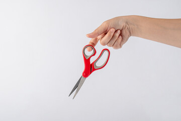 Hand holding office stationery scissors cutting on white background 