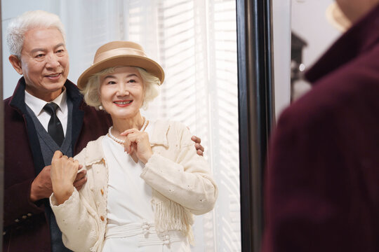 Stylish Older Couple Looking In The Mirror