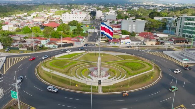 SAN JOSE, COSTA RICA - FEBRUARY 28, 2023 - Rotonda de la Bandera (The Flag) roundabout in San Pedro. Aerial drone view, backward movement, daylight.
