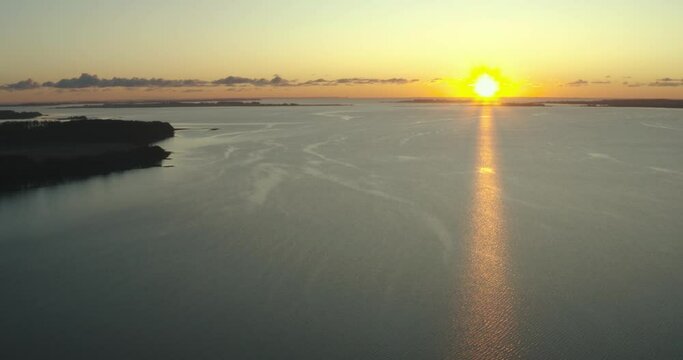 AERIAL: Drone footage of sunrise over a lake in Denmark.