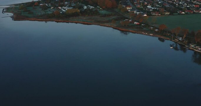 AERIAL: Drone footage of sunrise over a lake in Denmark.