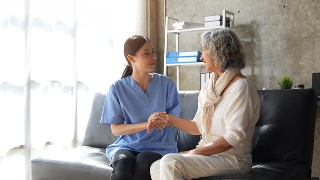 Female doctors shake hands with old woman patient encouraging each other To offer love, concern, and encouragement while checking the patient's health