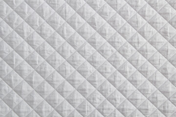 Quilted fabric. The texture of the blanket. White textile	ffffff