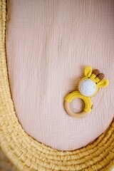 in a basket natural wooden knitted toys for a newborn. View from above - 591758546
