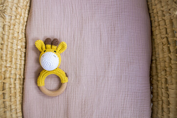in a basket natural wooden knitted toys for a newborn. View from above - 591758555