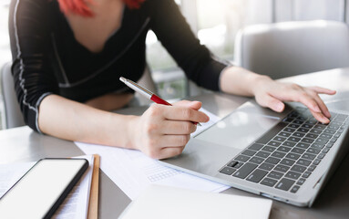 Cropped close up image young asian woman hands typing on laptop, businesswoman communicate online with her business group to make new business concept