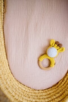 in a basket natural wooden knitted toys for a newborn. View from above