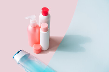 Background is divided into pink and blue color with personal care product.