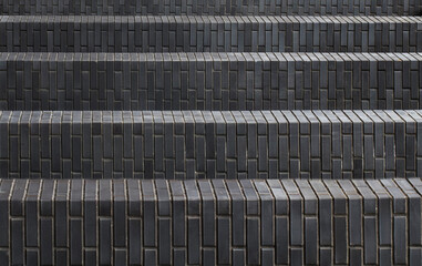 A fragment of a flight of stairs made of black bricks