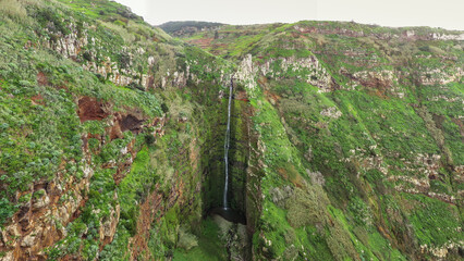 Waterfall plunges into the gorge at the Miradouro da Garganta Funda viewpoint on the island of Madeira in Portugal