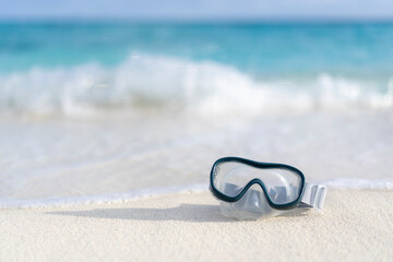 Diving goggles on an empty beach in the Maldives
