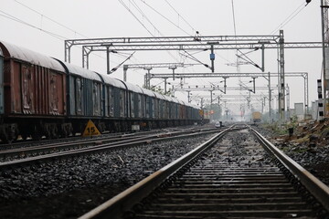 the indian goods train moving on railway track with empty sky