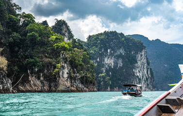 Naklejka na ściany i meble Amazed nature scenic landscape with boat for traveler, Attraction famous landmark tourist travel Khao Sok National Park, Thailand. Long tail boat trip