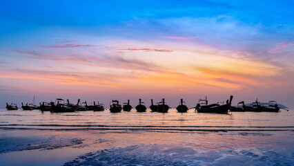Silhouette of Longtail boat at sunset. Railay beach in Krabi, Thailand.