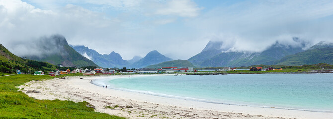 Summer cloudy view of the beach with white sand in Ramberg (Norway, Lofoten). People unrecognizable.