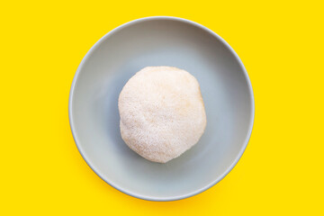Fresh lion's mane mushroom on yellow background.