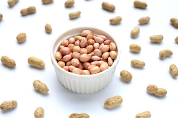 Raw peanuts on white background.