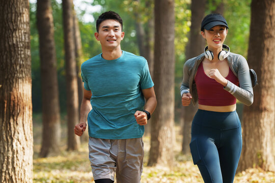 Young couples to running in the woods