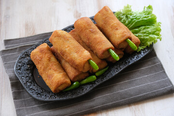 rissole or risoles ragout filled with chicken and vegetables , coating with bread crumb and deep fried
