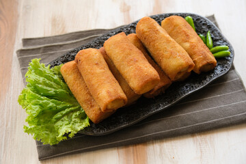 rissole or risoles ragout filled with chicken and vegetables , coating with bread crumb and deep fried
