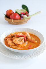tom yum kung, spicy Thai tom yum soup in white bowl
