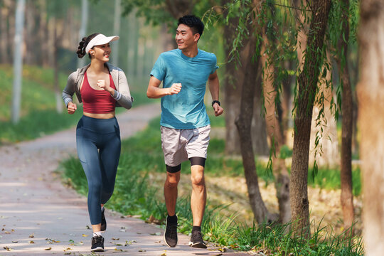 Young couples to running in the woods