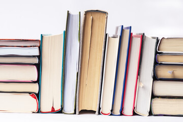 Books stacked vertically and horizontally. Fore edges.