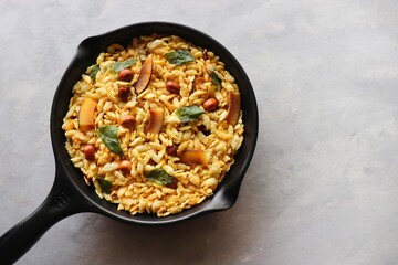 Jada Poha Namkeen Chivda or Thick Pohe Chiwda. Diwali special savory snack, made out of puffed rice, fried peanuts, curry leaves and some spices. Traditional Indian Diwali Snacks. with Copy Space.