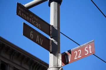 Fototapeta premium Brown West 22nd Street and 6th Avenue of Americas historic sign