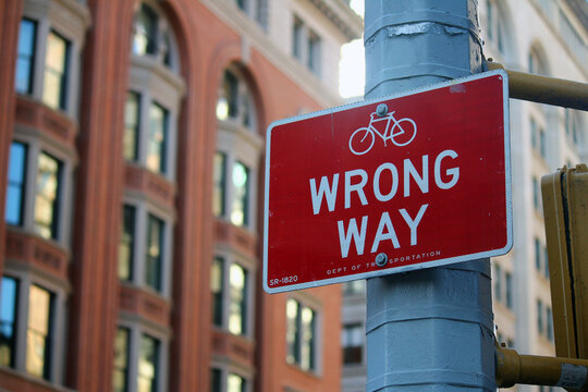 Red Wrong Way for bicycle direction traffic sign in Manhattan in New York City