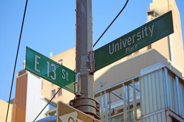 Green East 13th Street and University Place traditional sign in Midtown Manhattan