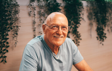 Close-up Portrait of Happy 70 Years Old Senior Man Smiling Looking at Camera. Relaxed Grandfather in Casual Clothing and Eyeglasses