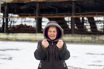 Elderly woman, grandmother, shows obscene gestures with her hands, Fuck off