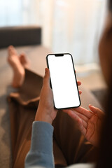 Close up view of woman hands holding smart phone. White empty screen for app or web site design